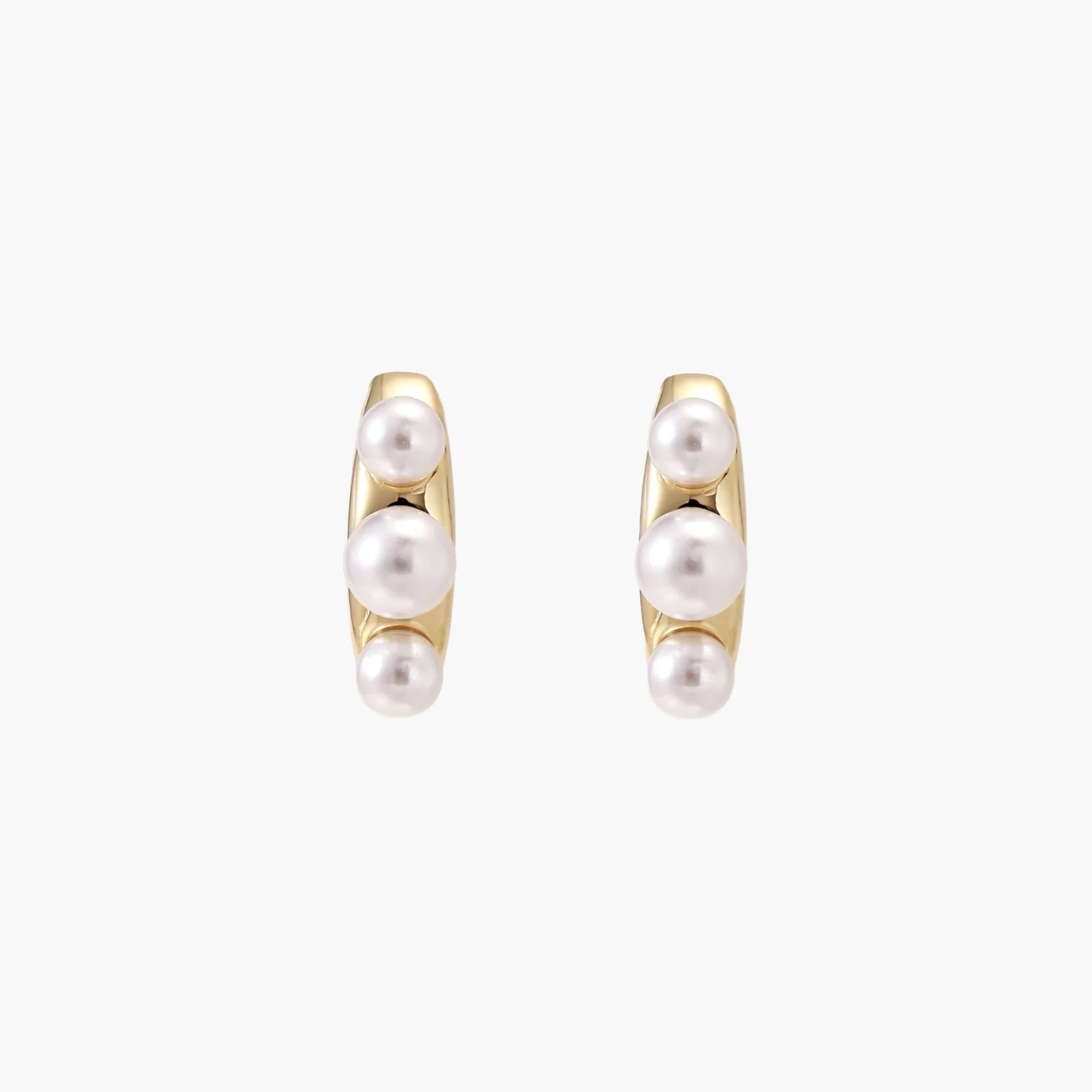 14K gold-plated curved stud earrings with three white freshwater pearls aligned vertically on cream background