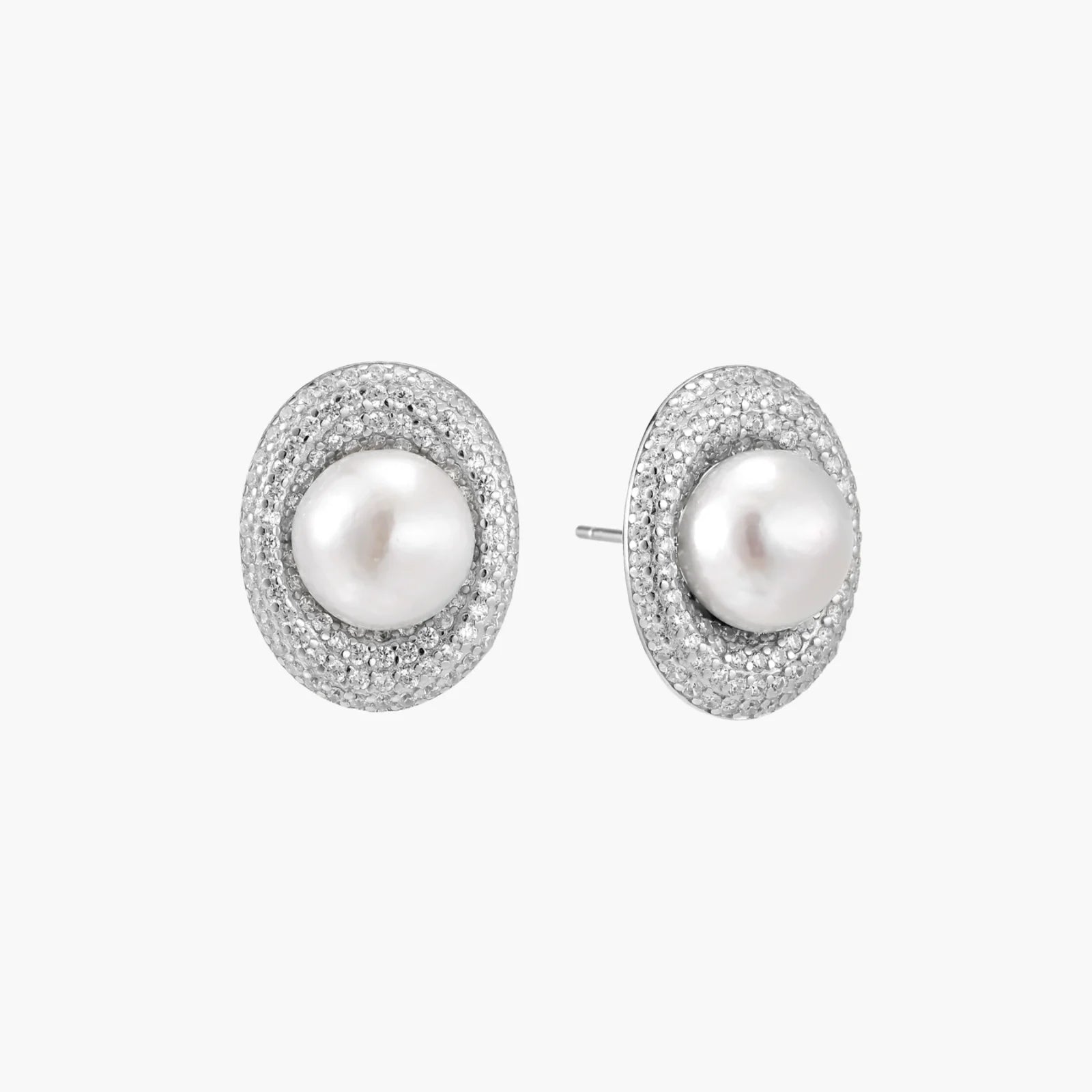 Oval rhodium-plated silver studs featuring freshwater pearls surrounded by pavé crystal halo on white background