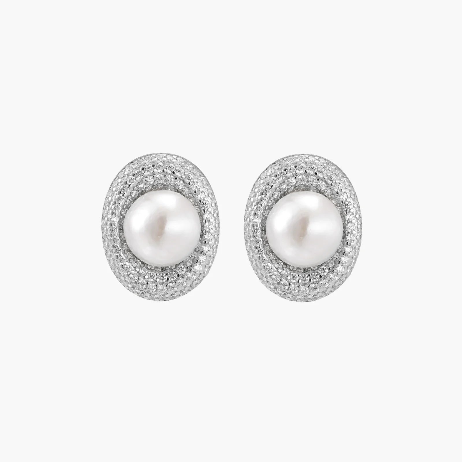 Oval rhodium-plated silver studs featuring freshwater pearls surrounded by pavé crystal halo on white background