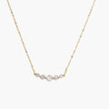 Delicate 14K gold-plated necklace with five graduated zirconia stones arranged in a curved arc on fine chain